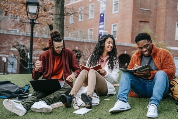 Multiethnic people sitting around studying notes.