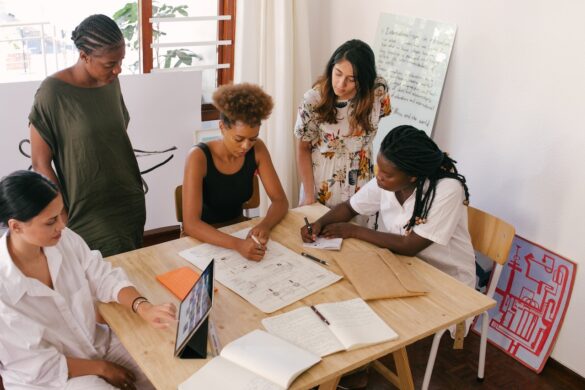 Women gathered around for a work meeting