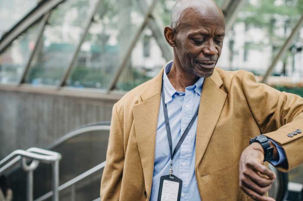 Older black man checking the time on his watch