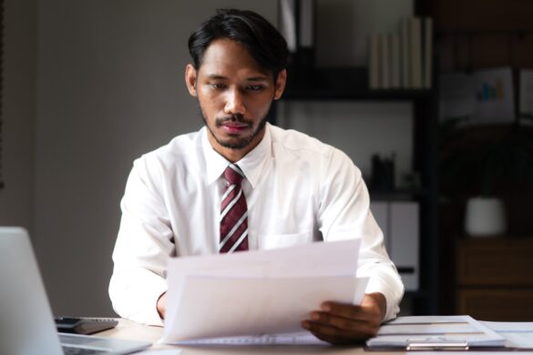 Businessman reading marketing graph document and analyzing strategy of startup business project