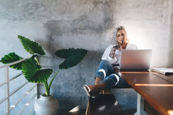 Pondering female blogger browsing media publication in social networks using laptop device