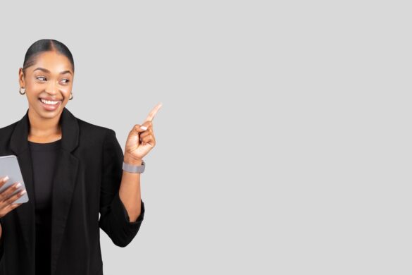 Confident African American businesswoman with a smartphone pointing upwards